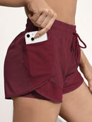 Shorts de ioga femininos de secagem rápida com bolso de tela.