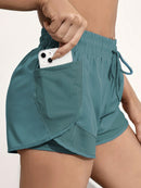 Shorts de ioga femininos de secagem rápida com bolso de tela.